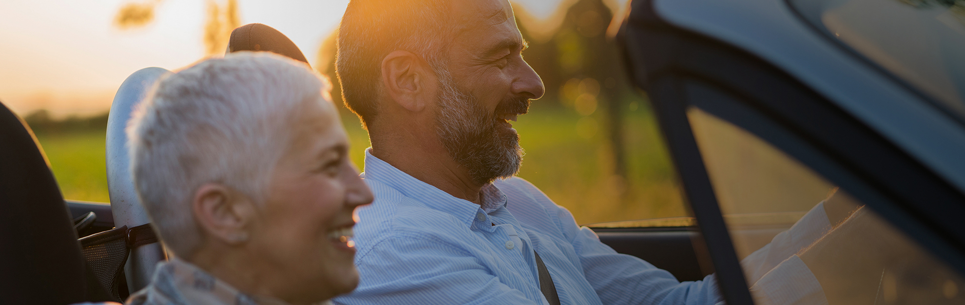 Man driving at sunset